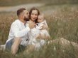 Happy family enjoying quality time in a serene meadow setting.